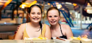 Meisjes aan de bar eten patat